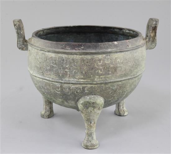 A Chinese archaic bronze tripod ritual food vessel, Ding, Eastern Zhou dynasty, 26.5cm wide, holes to base, cover lacking